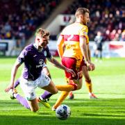 Will Fish is fouled by Stephen O'Donnell for Hibs' penalty against Motherwell