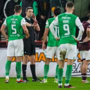 Referee Kevin Clancy speaks to the VAR before awarding Hearts a penalty during February's derby